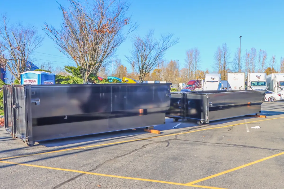 Professional dumpster rental service with roll-off container on residential driveway in North Liberty